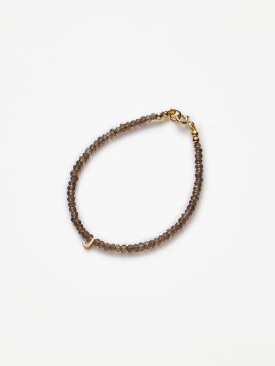 Hand-strung bracelet with natural smoky quartz gemstones and miniature three-dimensional letter in 18k solid gold