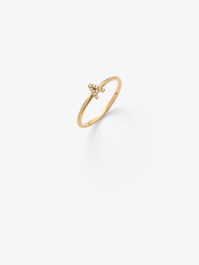 Close-up view of a luxurious gold pinky letter A ring adorned with sparkling diamonds, elegantly set against a neutral grey background