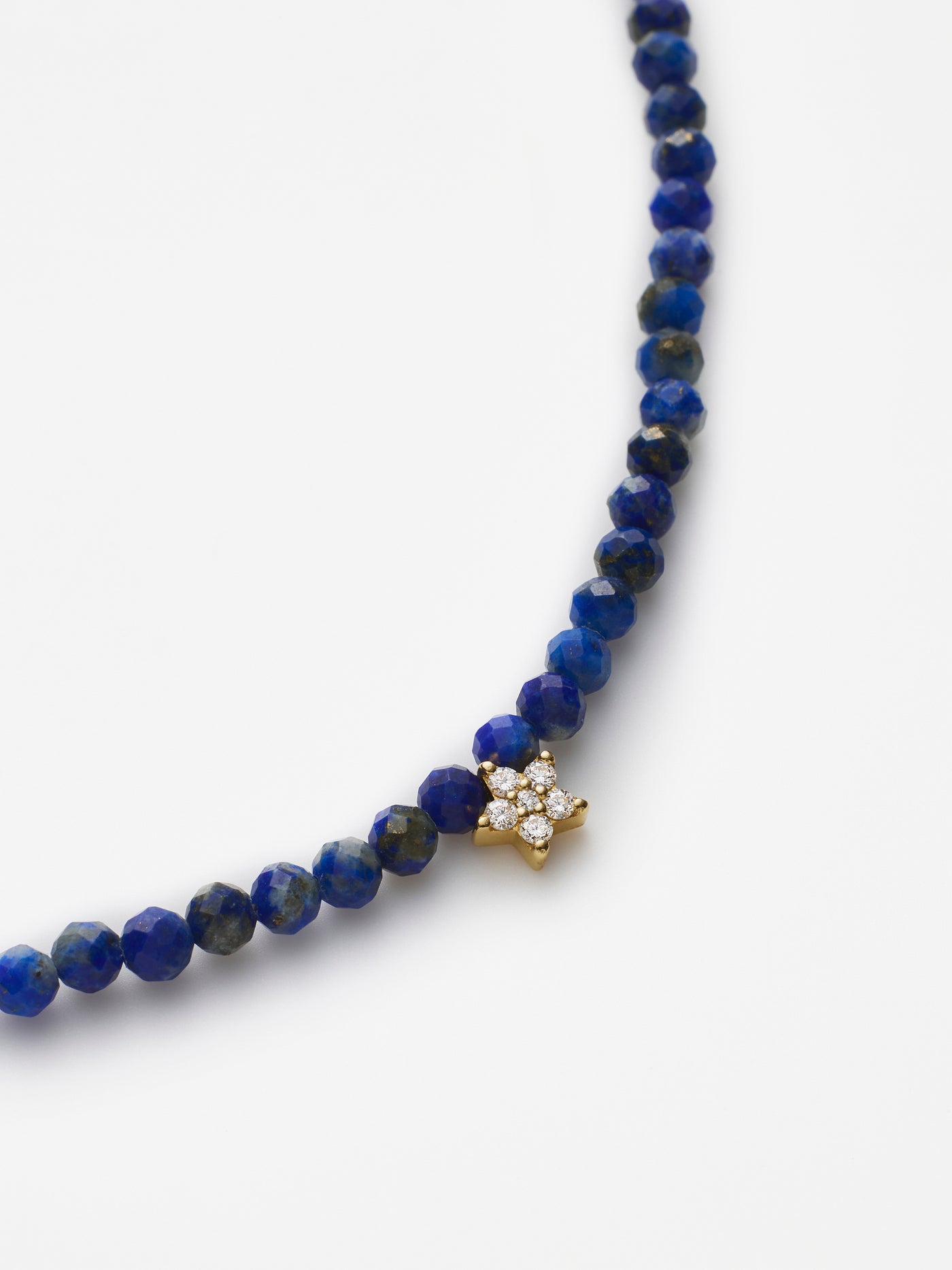 Hand-strung bracelet with natural lapis lazuli gemstones and miniature three-dimensional diamond star in 18k solid gold