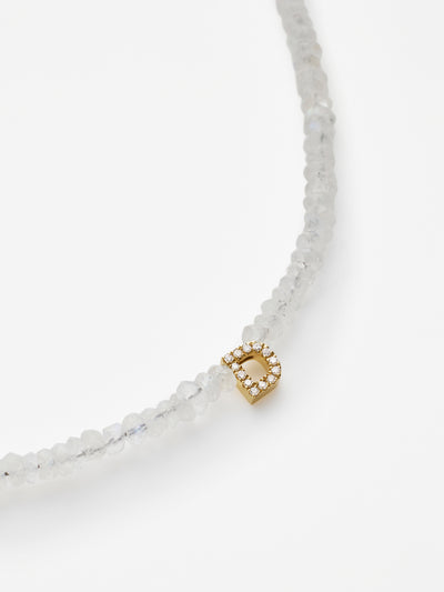 Hand-strung bracelet with natural rainbow moonstone gemstones and miniature three-dimensional diamond letter in 18k solid gold