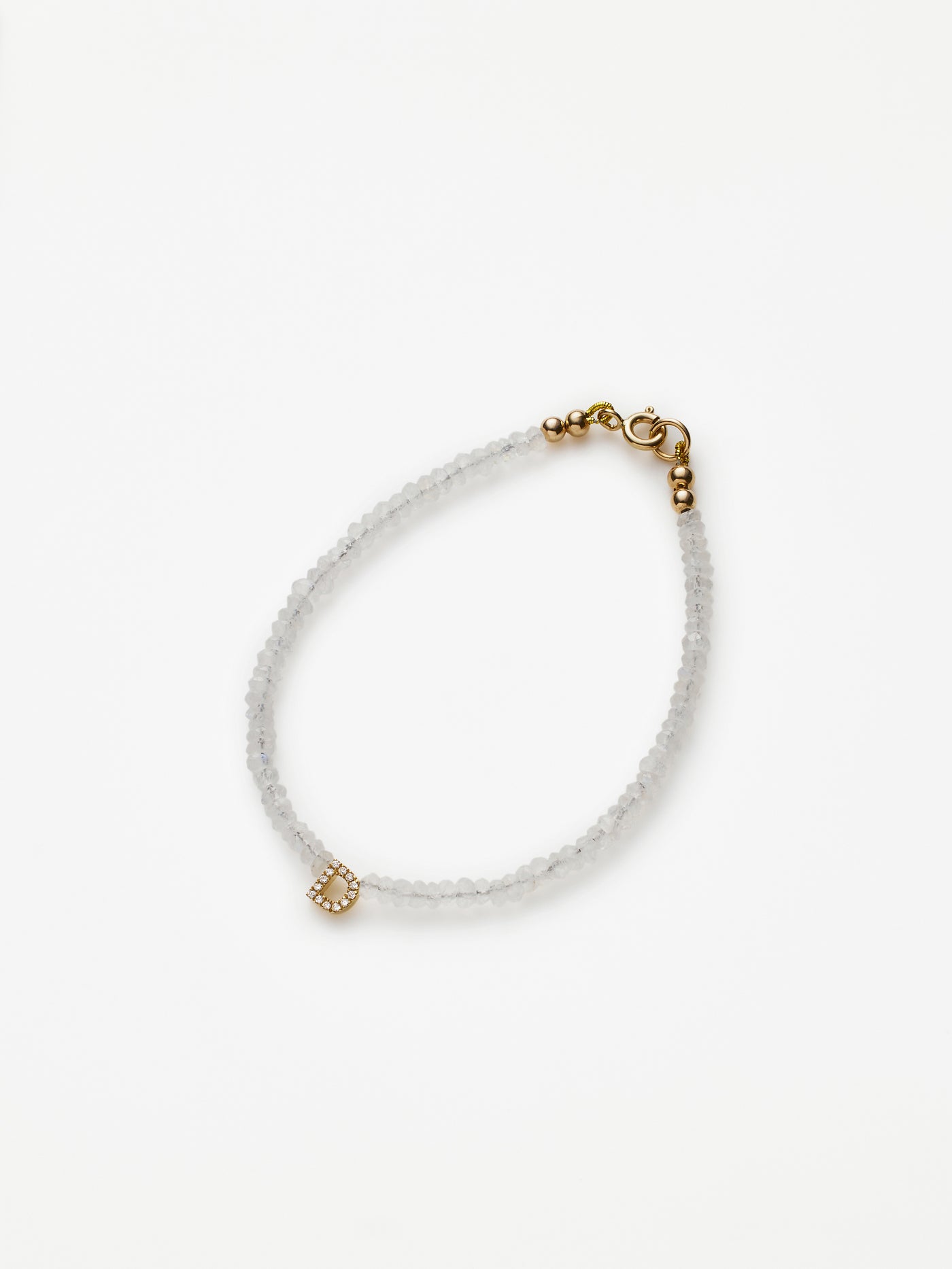 Hand-strung bracelet with natural rainbow moonstone gemstones and miniature three-dimensional diamond letter in 18k solid gold